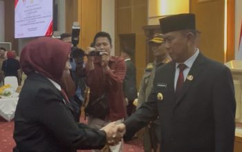 Gubernur Sultra, Andi Sumangerukka saat memberikan selamat kepada Nur Aida usai resmi dilantik sebagai Kepala SMAN 1 Kendari. (FOTO: FAYSAL/MS)